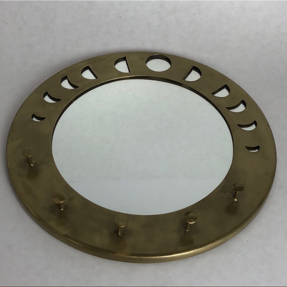 Gold circle mirror with jewelry hangers